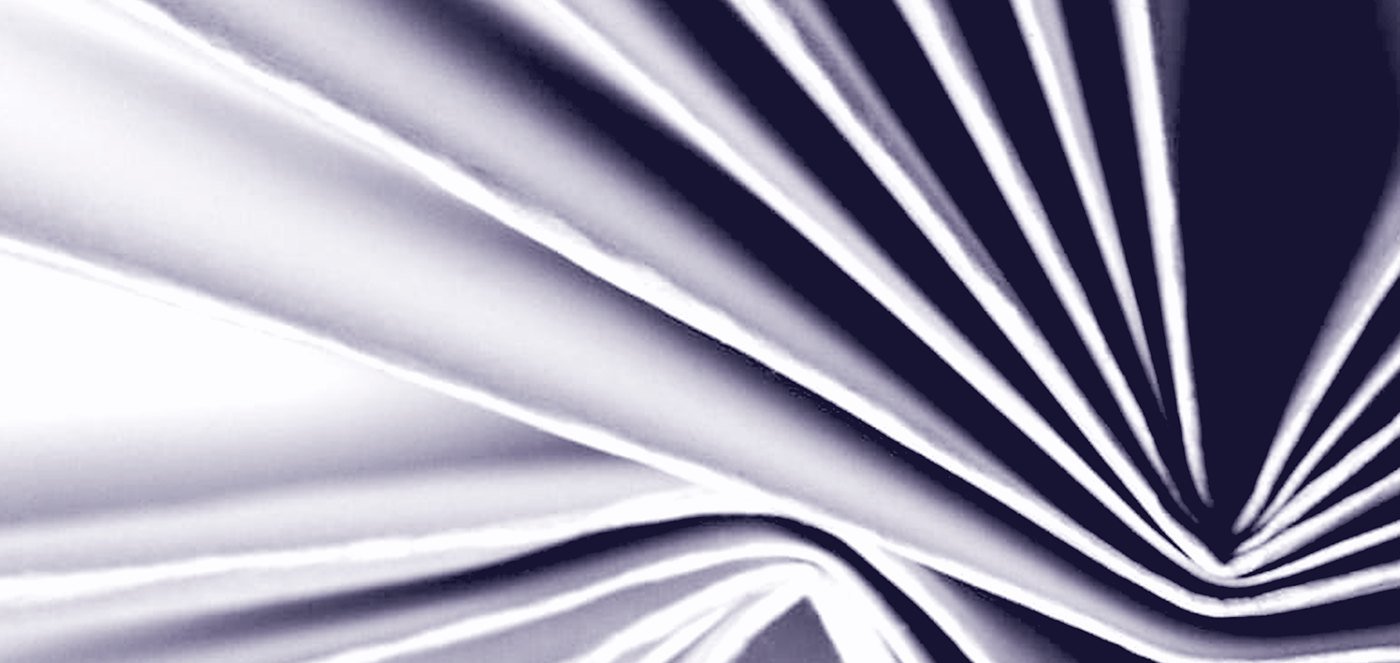 A fan of white paper folds, high key, the pleats converging