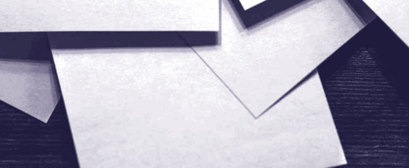 Folded paper, the light raking across the creases
