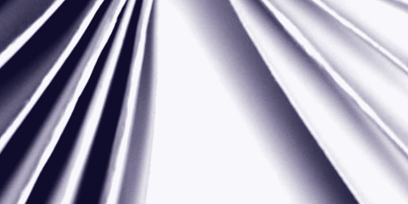 Paper pleats radiating from a single point, lit hard from one side