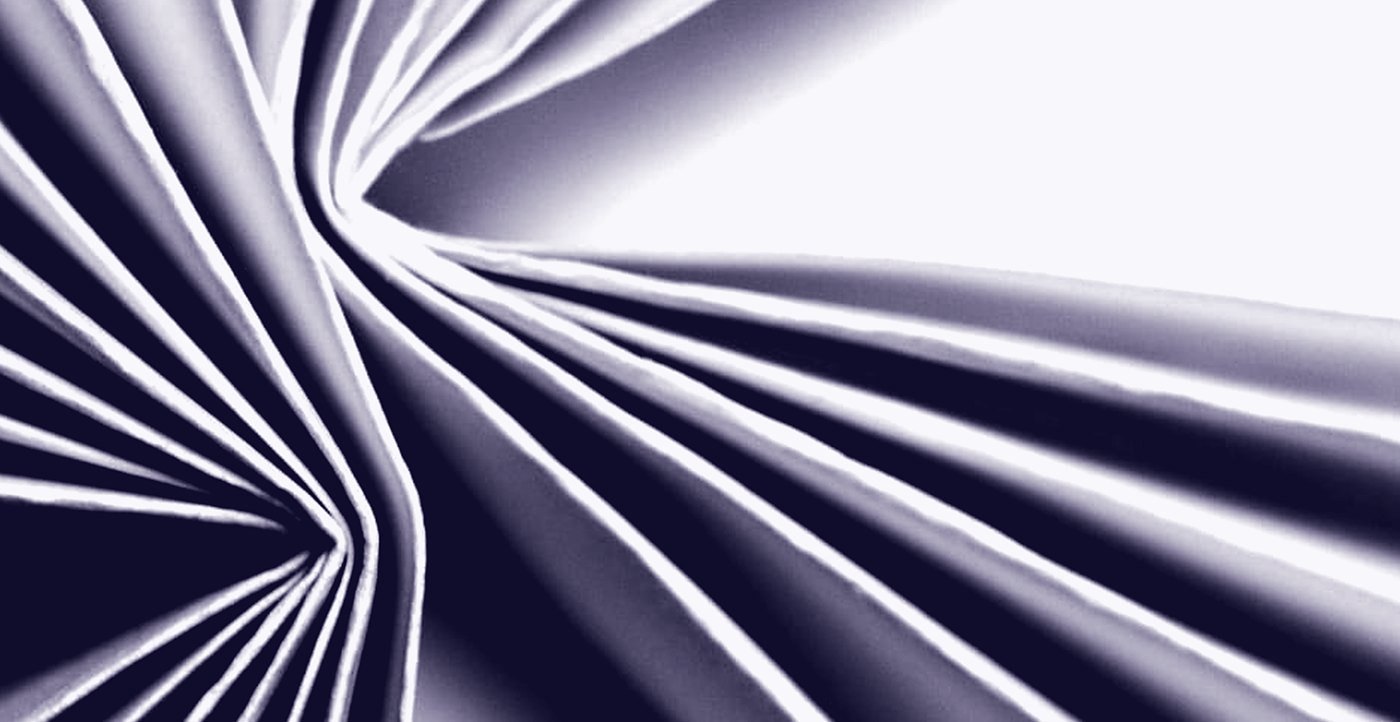 Folded paper, the light raking across the creases