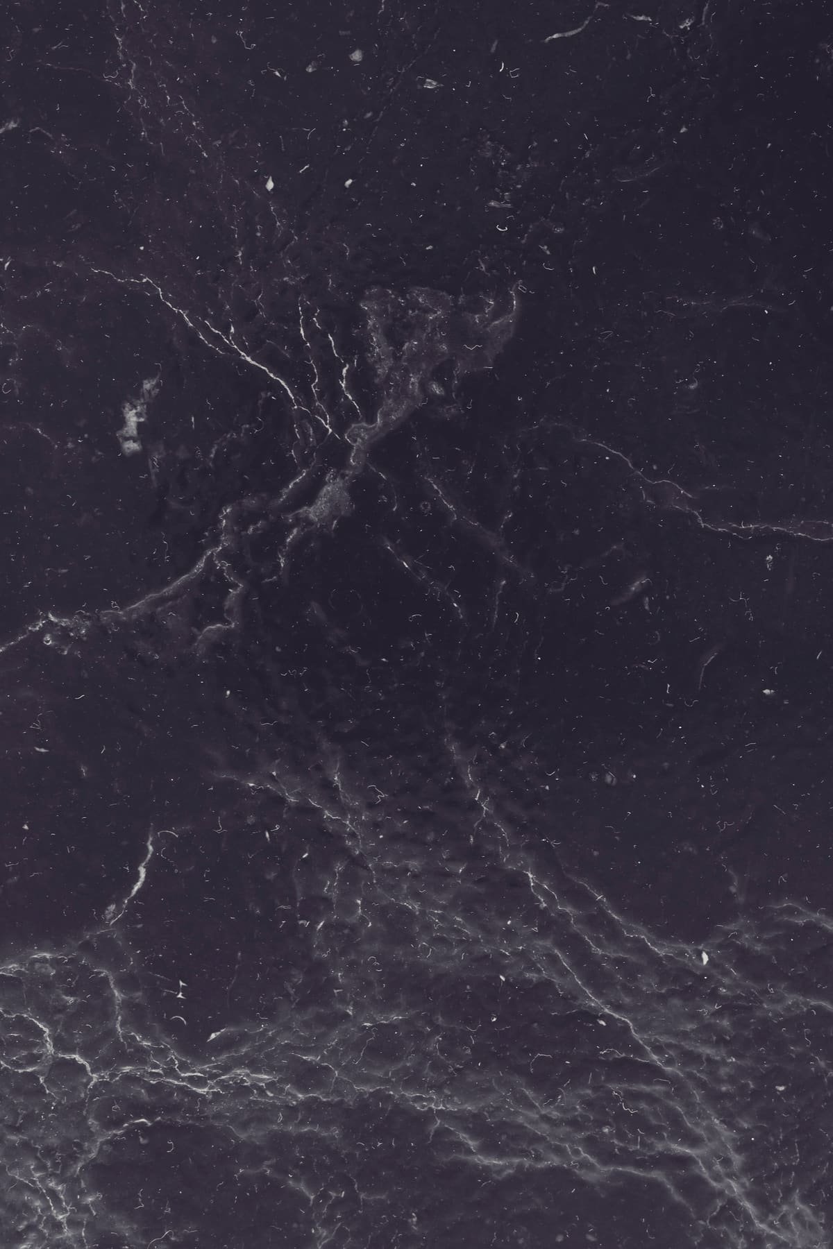 Dark slate under low light, its surface faintly veined