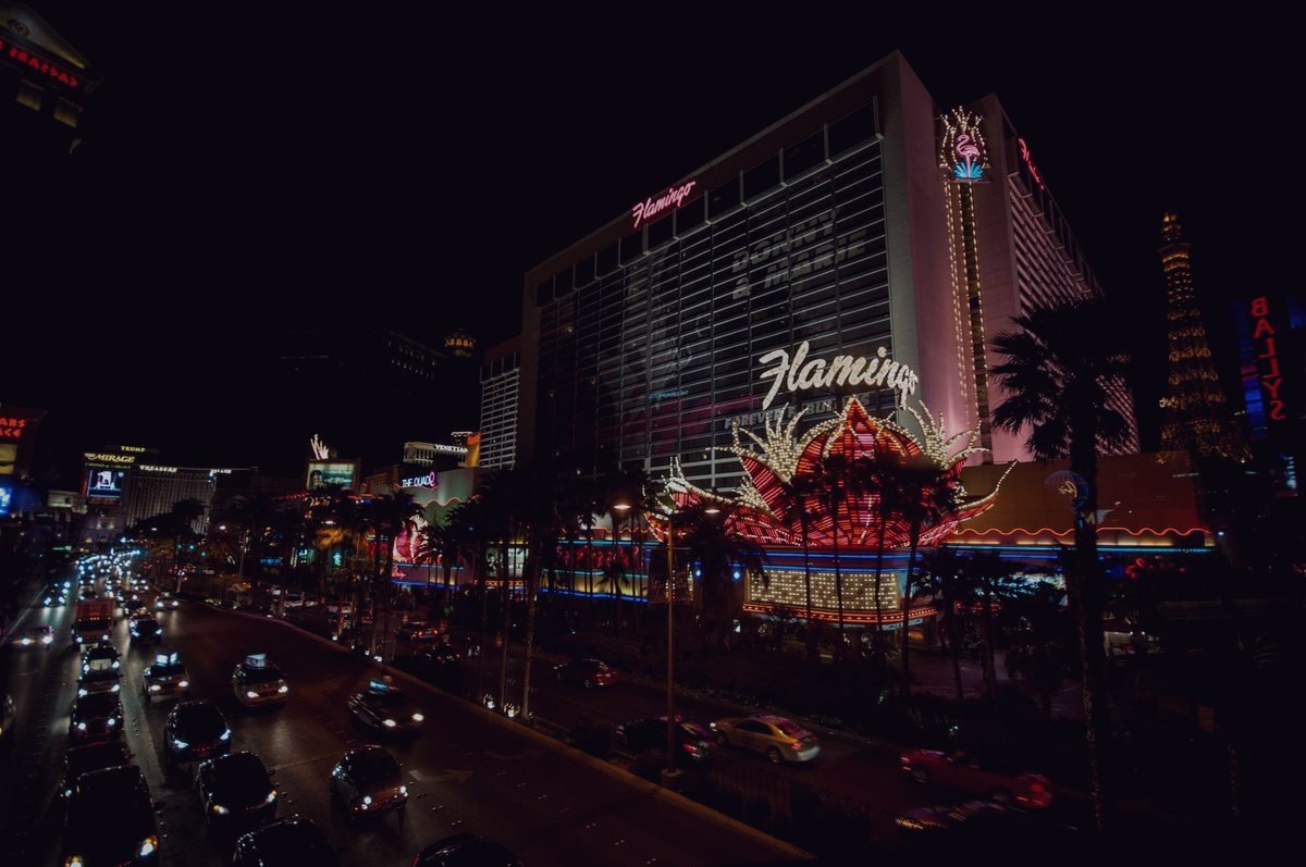 Neon signage burning along the Las Vegas Strip at night.